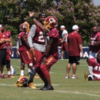 Redskins safety Kyshoen Jarrett dances to music before the start of practice. Photo by Terri Russell.