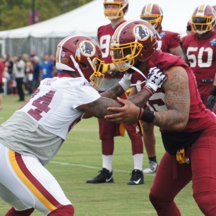 Tight end Niles Paul and linebacker Pete Robertson participate in a drill. (Photo by Jake Russell)