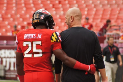 Maryland defensive back Antoine Brooks Jr. and interim head coach Matt Canada converse before the game. (Photo by Jake Russell)