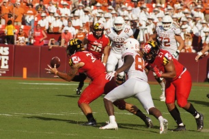 Maryland linebacker Tre Watson secures an interception. (Photo by Jake Russell)