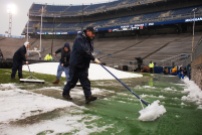 Beaver Stadium employees work to clear slush from the field. (Photo by Jake Russell)