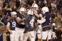 The Nittany Lions celebrate running back Ricky Slade's first rushing touchdown of the game. (Photo by Jake Russell)